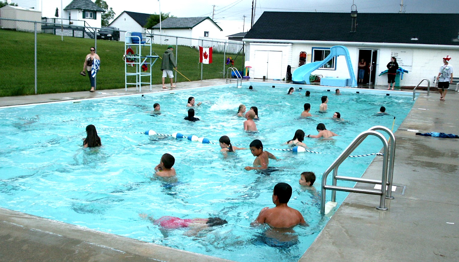 People enjoying the outdoor pool in Smooth Rock Falls. 